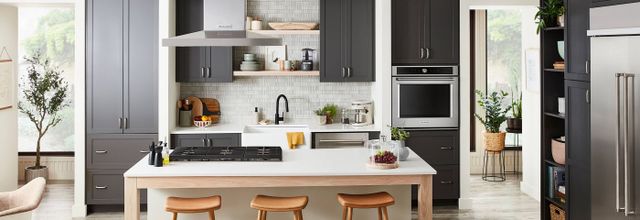 Front view of a modern kitchen with a built in KitchenAid convection oven