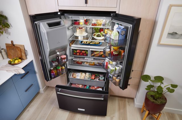 front view of a large black kitchenaid french door refrigeration opened