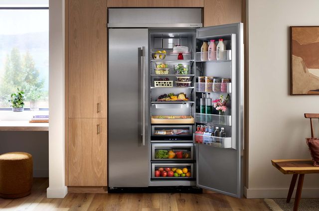 Credit: KitchenAid Front view of a modern kitchen with an opened side-by-side KitchenAid refrigerator