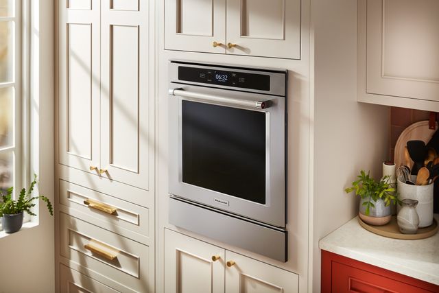 Front view of a modern kitchen with a KitchenAid convection wall oven