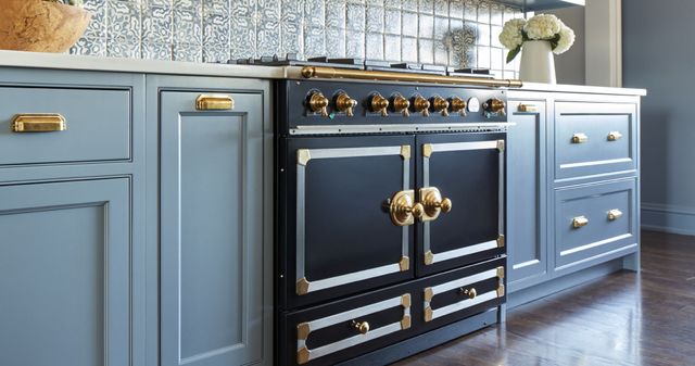 front left view of a black la cornue range in light blue cabinets of a modern luxury kitchen