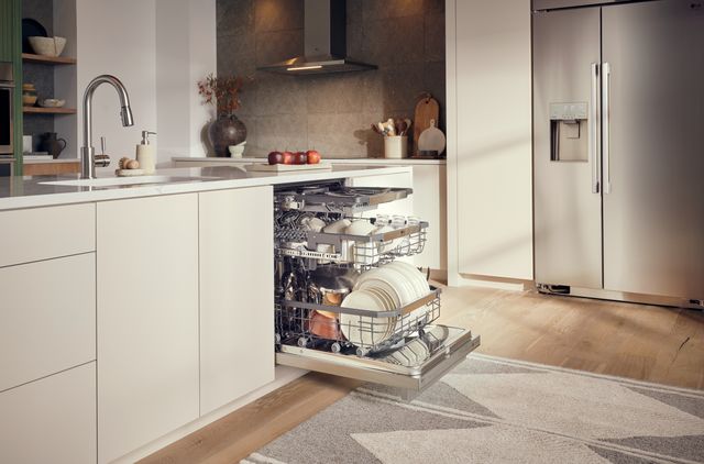 Front view of a modern kitchen with an LG Signature opened 18" dishwasher