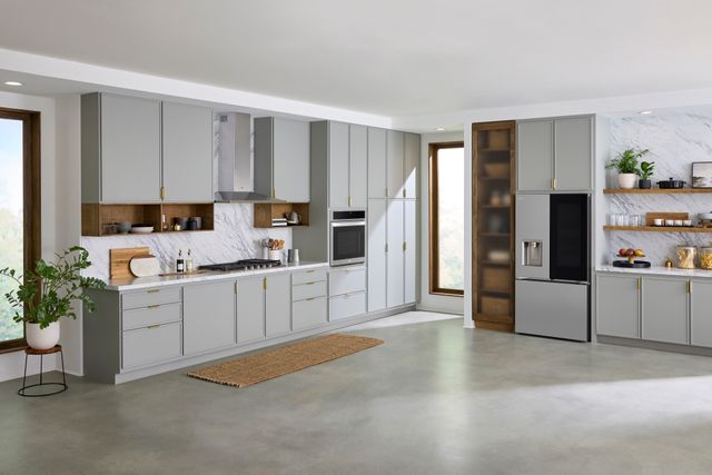 Front view of a modern kitchen with a gas cooktop and range hood