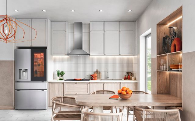 Front view of a modern kitchen with an LG smart refrigerator with a glass door.