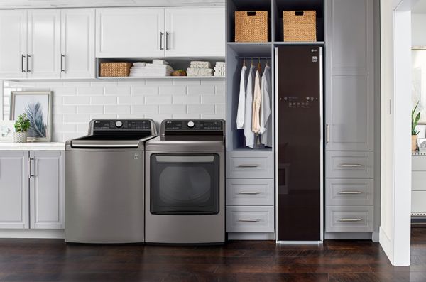 Top load washer, dryer, and the LG Styler are shown in a laundry room