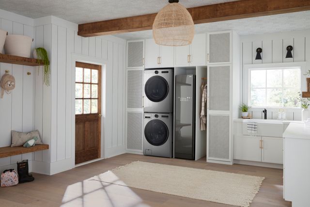 Front view of a modern laundry room with a stackable washer and dryer