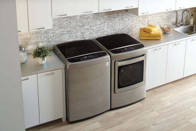 Front view of an LG top load washer and dryer in a modern laundry room