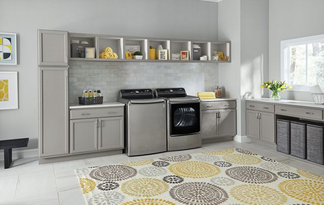 Front view of a modern laundry room with an LG top load washer and dryer