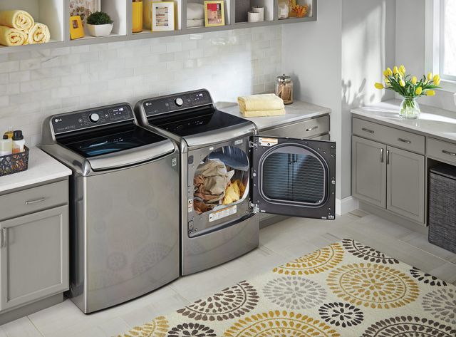 Front view of a modern laundry room with an opened LG dryer
