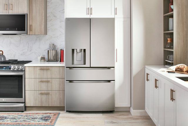 Front view of a modern kitchen with an LG stainless steel french door refrigerator