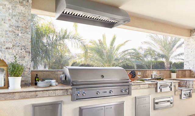 front view of a modern outdoor kitchen with a natural gas grill and various outdoor kitchen appliances throughout
