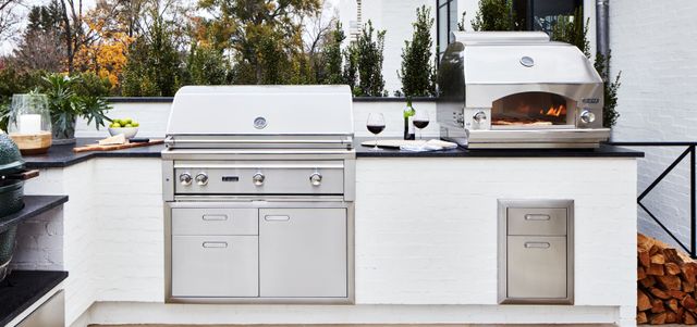 front view of an outdoor kitchen with a grill and pizza oven