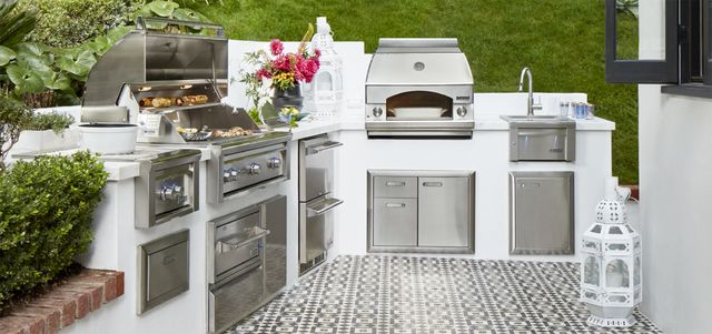 front view of a modern outdoor kitchen with various stainless steel appliances