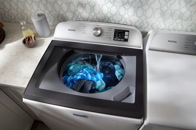 View of a Maytag top load washer with a glass top so you can see the water filling inside