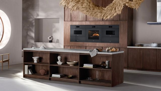 Front view of a modern kitchen with a Miele steam oven and microwave in wall