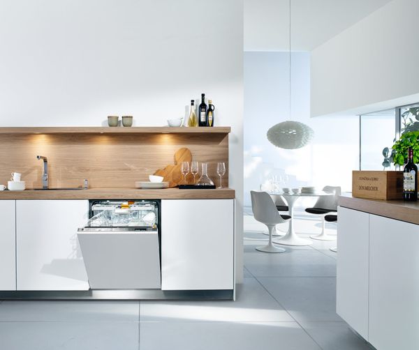 White panel ready Miele dishwasher in a kitchen with white cabinets