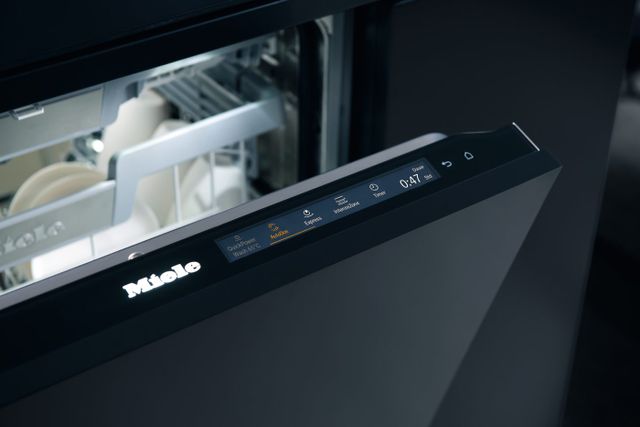 close view of a Miele dishwasher on the AutoDos setting