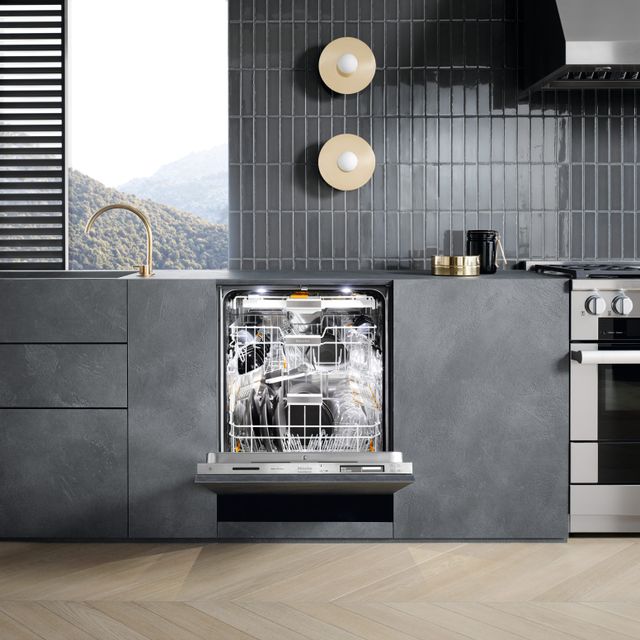 Credit: Miele Front view of a modern kitchen with an opened Miele dishwasher