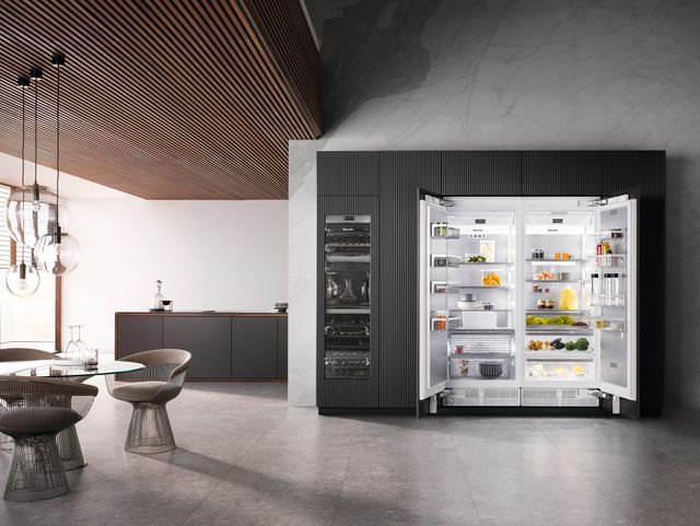 Front view of a luxury kitchen with an opened Miele side by side refrigerator