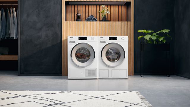 Front view of a modern laundry room with a Miele washer and dryer