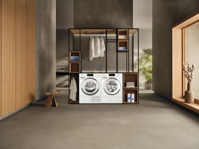 Credit: Miele Front view of a modern closet with a small Miele washer and dryer
