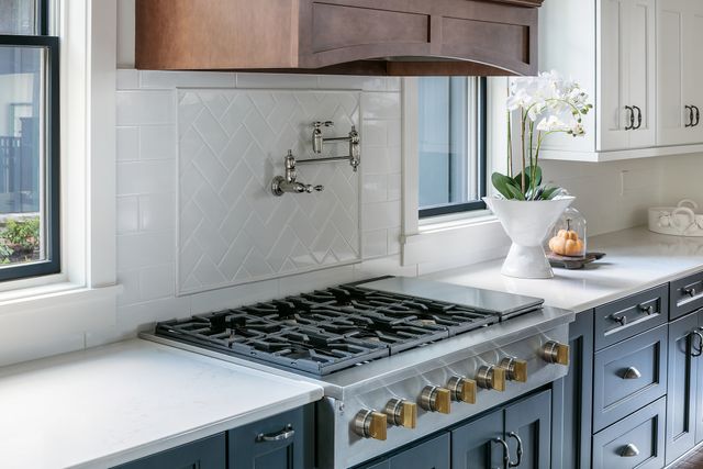 Front view of a modern kitchen with a Monogram gas rangetop