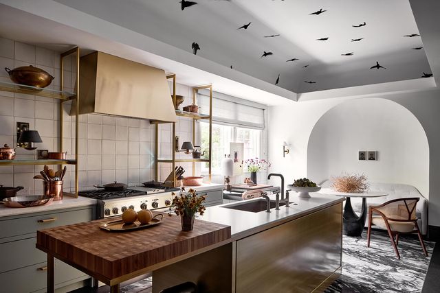 Front view of a luxurious kitchen with a 48" Monogram range and various gold accents