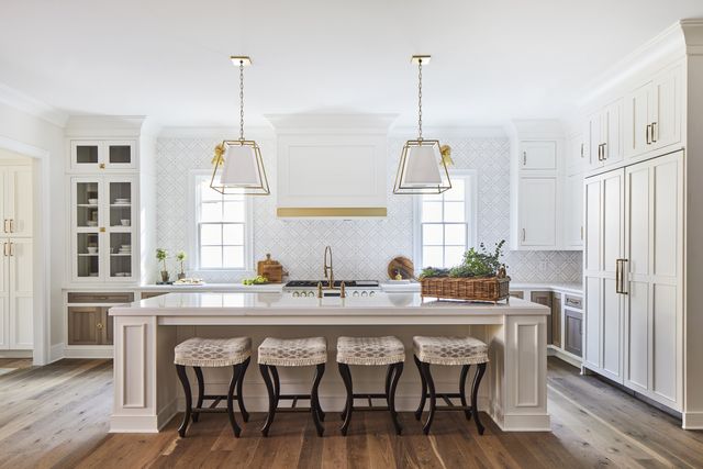front view of a white transitional kitchen with built in Monogram appliances and refrigerators