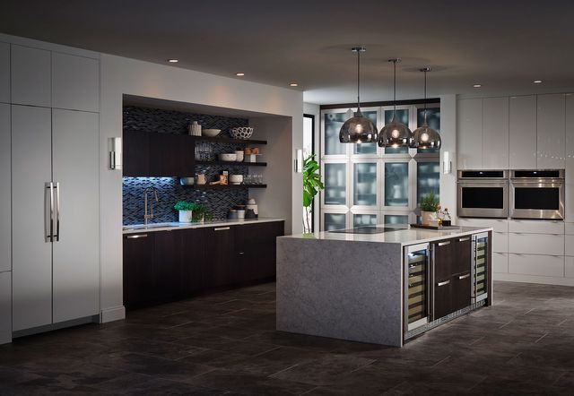 View of a modern industrial style kitchen with built in Monogram appliances