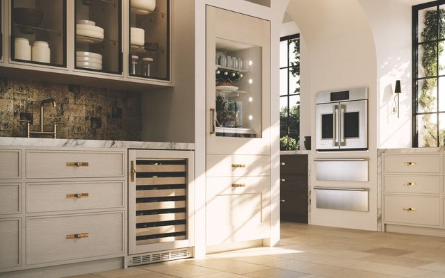 View of a modern kitchen with a Monogram bottom freezer refrigerator with ice maker