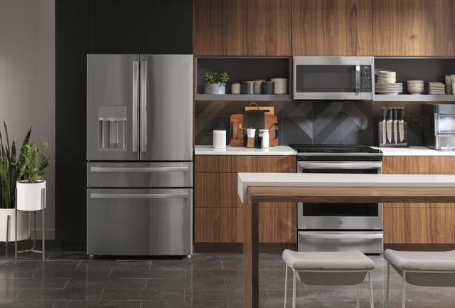 Front view of a modern kitchen with a GE Profile french door refrigerator