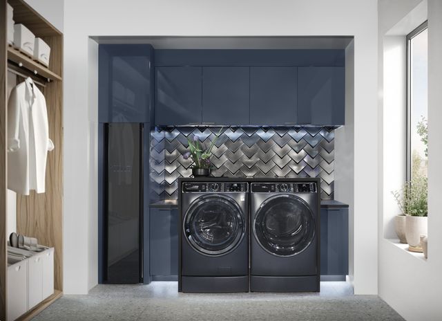 Front view of a modern laundry room with a blue washer and dryer
