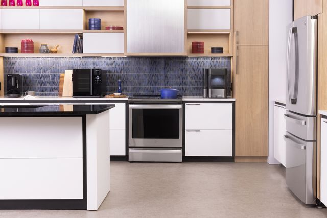 Front view of a modern kitchen with a GE Profile slide in induction range