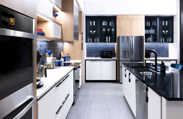 Front view of a modern kitchen with an island and GE Profile appliances