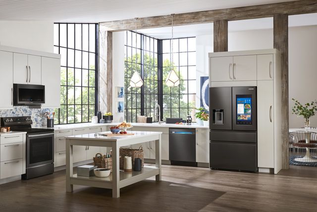 View of a modern kitchen with large windows and black stainless steel samsung appliances