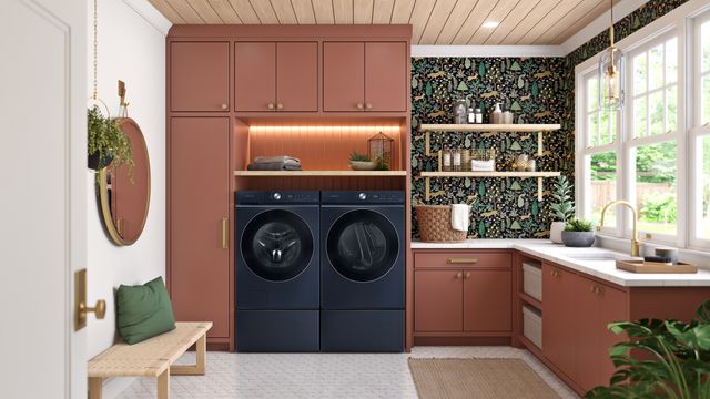 Front view of a modern laundry room with pink cabinetry and a blue Samsung washer and dryer.