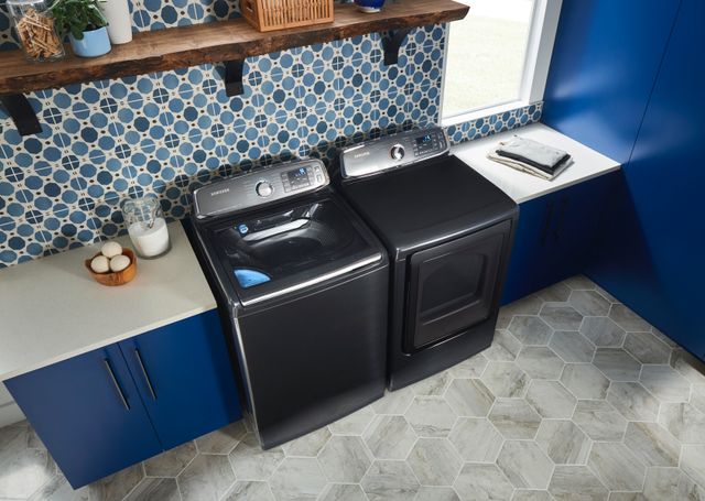 top angled view of a grey samsung washer and dryer in amodern blue laundry room