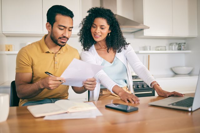 front view of a couple reviewing financing options