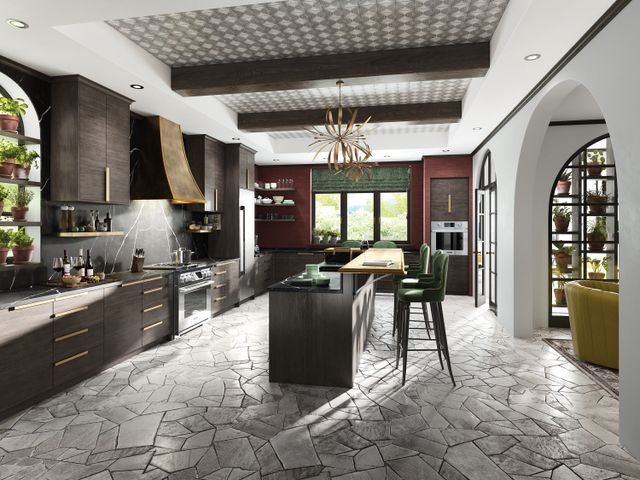 front view of a luxury kitchen with a signature kitchen suite refrigerator, range, and range hood around a large island