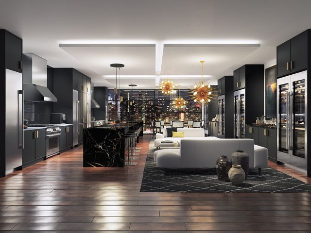 front view of a large luxury kitchen and living area with various Signature Kitchen Suite appliances