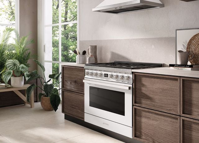 front view of a modern kitchen with a Smeg range and range hood