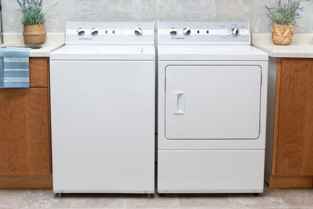 front view of the Speed Queen TC5 washer and DR7 dryer sitting together in a modern laundry area