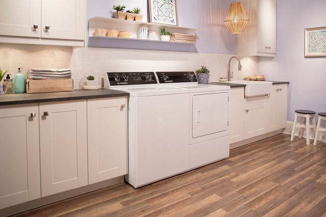 Front view of a modern laundry room with a white Speed Queen washer and dryer