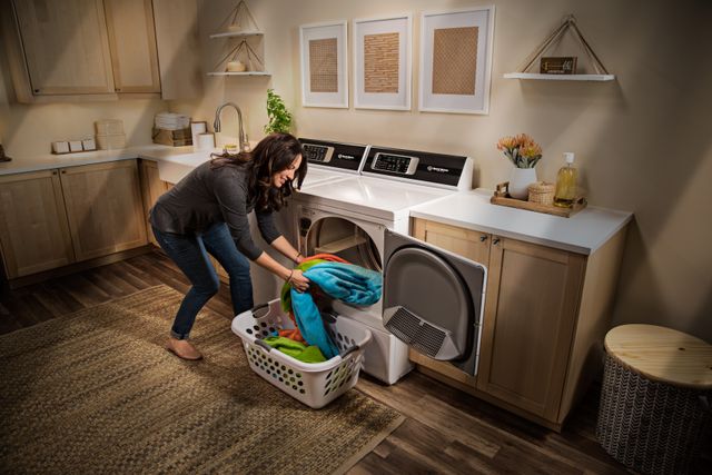 front view of a woman unloading her speed queen dryer