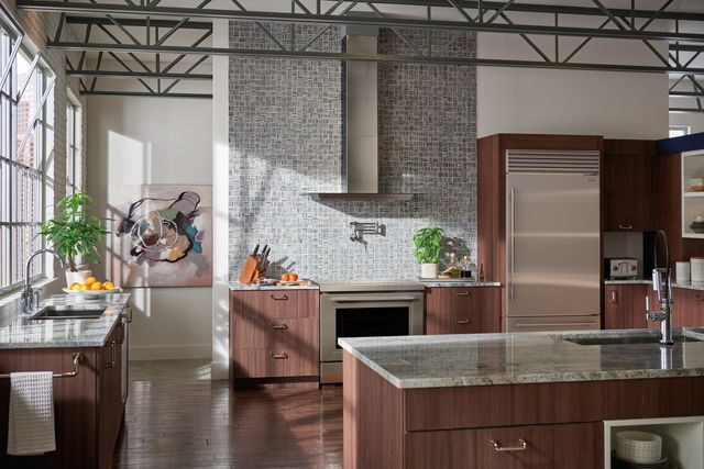 front view of a modern industrial kitchen with sub-zero, wolf, and cove appliances throughout