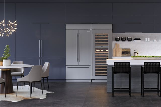 front view of a modern kitchen with grey panel cabientry walls with a Sub-Zero refrigerator and wine cooler built in