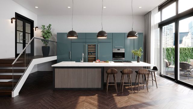 Front view of a modern kitchen with blue cabinetry and various sub-zero panel ready refrigerators