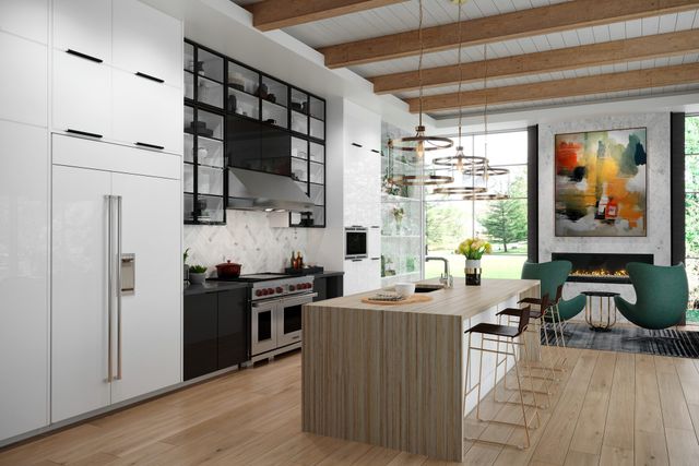 Angled view of an open concept kitchen and living room with white cabinetry in the foreground and a panel ready built in refrigerator