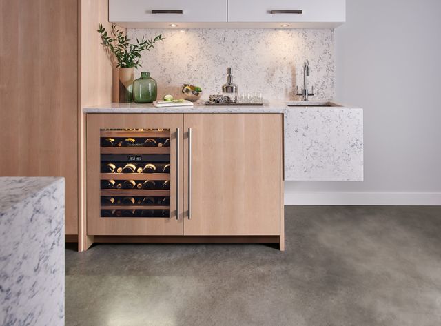 Front view of a modern panel-ready under counter wine refrigerator in a modern home