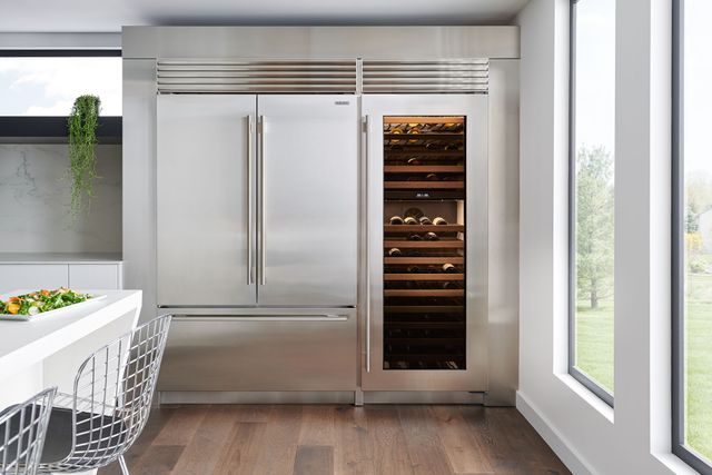 Front view of a large Sub-Zero refrigerator and wine column built into a modern kitchen